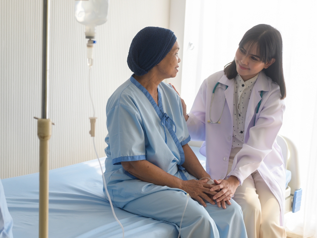 Nurse assisting patient with recovery care at home after hospital discharge.